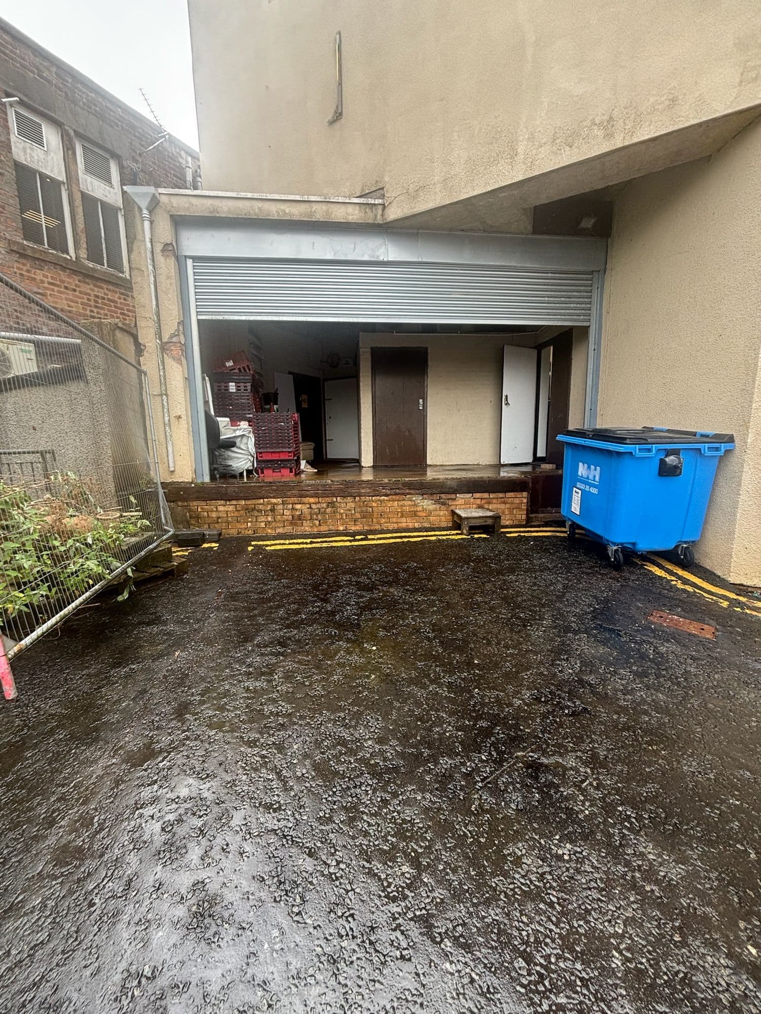 After: The same rear service yard after cleaning, washed down and clear